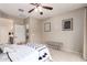 Well-lit primary bedroom offers a bench seat and access to a private bathroom at 17907 W Cedarwood Ln, Goodyear, AZ 85338