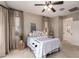 Light-filled primary bedroom with a ceiling fan and neutral tones creates a relaxing atmosphere at 17907 W Cedarwood Ln, Goodyear, AZ 85338