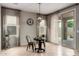 Sun-drenched breakfast nook features a round table and access to the outdoor space through sliding glass doors at 17907 W Cedarwood Ln, Goodyear, AZ 85338