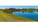 Picturesque lake reflecting the community clubhouse and lush landscaping at 17907 W Cedarwood Ln, Goodyear, AZ 85338