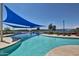 Resort-style community pool with shade canopies and comfortable lounge seating at 17907 W Cedarwood Ln, Goodyear, AZ 85338
