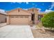 Beautiful single story home with a two car garage, red tile roof, stone accents, and desert landscaping at 17907 W Cedarwood Ln, Goodyear, AZ 85338