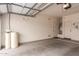 Clean two-car garage with painted walls, high ceilings, and a water filtration system at 17907 W Cedarwood Ln, Goodyear, AZ 85338