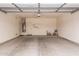 Spacious two-car garage with painted walls, high ceilings, and storage shelves, providing ample parking and storage at 17907 W Cedarwood Ln, Goodyear, AZ 85338
