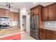 This kitchen boasts a large stainless steel refrigerator, granite counters, and a subway tile backsplash at 17907 W Cedarwood Ln, Goodyear, AZ 85338