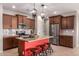 Stylish kitchen boasts a bright red island, modern appliances, and a subway tile backsplash at 17907 W Cedarwood Ln, Goodyear, AZ 85338