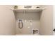 Neutral laundry room with plenty of outlets and shelves perfect for laundry and other household needs at 17907 W Cedarwood Ln, Goodyear, AZ 85338