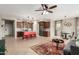 Open-concept living space with a kitchen island, ceiling fan, tile floors, and comfortable furnishings and a view at 17907 W Cedarwood Ln, Goodyear, AZ 85338
