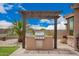 Built-in outdoor grill surrounded by a beautifully hardscaped patio with clear blue skies above at 17907 W Cedarwood Ln, Goodyear, AZ 85338