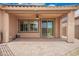 Covered patio with brick pavers, ceiling fan, and sliding glass door for easy indoor-outdoor living at 17907 W Cedarwood Ln, Goodyear, AZ 85338