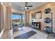 Exercise room with weights, yoga mats, and sliding glass doors that lead to the backyard at 18438 W Mohave St, Goodyear, AZ 85338