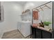 Neat laundry room features modern washer and dryer, shelving, and storage solutions at 18438 W Mohave St, Goodyear, AZ 85338