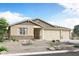 Charming single-story home with desert landscaping and a three car garage at 18450 W Mohave St, Goodyear, AZ 85338