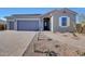 Attractive single-story home with a three-car garage, paver driveway, and desert landscaping for low maintenance at 18462 W Mohave St, Goodyear, AZ 85338