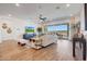 Spacious living room with wood floors, a ceiling fan, and access to the outdoor patio at 18462 W Mohave St, Goodyear, AZ 85338