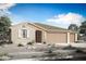 Charming single-story home featuring a tile roof, neutral stucco, desert landscaping and a spacious two car garage at 18534 W Mohave St, Goodyear, AZ 85338