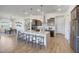 Spacious kitchen with large island, seating, stainless steel appliances, and modern pendant lighting at 18534 W Mohave St, Goodyear, AZ 85338