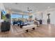 Bright living room with wood floors, modern decor, and sliding glass doors to outdoor living at 18534 W Mohave St, Goodyear, AZ 85338