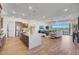 Open-concept living space featuring a kitchen island and living room with backyard access at 18534 W Mohave St, Goodyear, AZ 85338