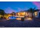 Inviting backyard with a sparkling pool, lounge chairs, and ambient lighting for entertaining at 19414 W Pasadena Ave, Litchfield Park, AZ 85340
