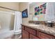 Bathroom with a tub and single sink vanity offering ample counter space and storage at 19414 W Pasadena Ave, Litchfield Park, AZ 85340