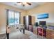 Versatile bedroom space with a desk area, a foosball table, a ceiling fan, and great natural light at 19414 W Pasadena Ave, Litchfield Park, AZ 85340