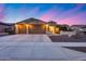 Beautiful home featuring a three-car garage, desert landscaping, and a well-manicured lawn at 19414 W Pasadena Ave, Litchfield Park, AZ 85340