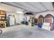 Spacious garage with ample storage, white walls and door, and concrete floor, ideal for organization and projects at 19414 W Pasadena Ave, Litchfield Park, AZ 85340