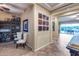 Inviting hallway with neutral tones and unique art leading to a bright outdoor view at 19414 W Pasadena Ave, Litchfield Park, AZ 85340