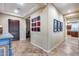 Spacious hallway featuring unique artwork, tile flooring, and an inviting atmosphere at 19414 W Pasadena Ave, Litchfield Park, AZ 85340