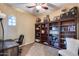 Cozy home office with a large, well-organized wooden bookshelf and comfortable workspace at 19414 W Pasadena Ave, Litchfield Park, AZ 85340