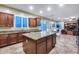 Spacious kitchen features granite countertops, an island, and stainless steel appliances with great natural light at 19414 W Pasadena Ave, Litchfield Park, AZ 85340