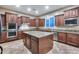 Spacious kitchen featuring an island, granite countertops, and stainless steel appliances at 19414 W Pasadena Ave, Litchfield Park, AZ 85340