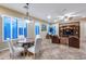 Bright living room featuring tile flooring, ample windows with shutters, and a built-in entertainment center at 19414 W Pasadena Ave, Litchfield Park, AZ 85340