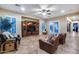 Spacious living room features tile flooring, ample windows with shutters, and a built-in entertainment center at 19414 W Pasadena Ave, Litchfield Park, AZ 85340
