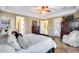 Comfortable main bedroom with tile flooring, ample natural light, and an ensuite bathroom with a walk-in shower at 19414 W Pasadena Ave, Litchfield Park, AZ 85340