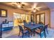 Outdoor patio with dining table, ceiling fans, and views of the beautifully landscaped backyard at 19414 W Pasadena Ave, Litchfield Park, AZ 85340