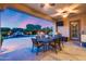 Inviting outdoor patio with a dining table and seating, overlooking the pool and fire pit at 19414 W Pasadena Ave, Litchfield Park, AZ 85340