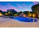 Inviting backyard pool featuring rock waterfall, manicured landscaping, and a serene ambiance perfect for relaxation at 19414 W Pasadena Ave, Litchfield Park, AZ 85340