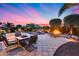 Stunning backyard featuring a pool with rock waterfall, a fire pit, and lounge seating at 19414 W Pasadena Ave, Litchfield Park, AZ 85340
