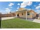 This backyard features a covered patio, well-maintained yard, and secure fencing at 1945 W Renaissance Ave, Apache Junction, AZ 85120