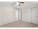 This bedroom features neutral flooring, a ceiling fan, and a mirrored closet at 1945 W Renaissance Ave, Apache Junction, AZ 85120