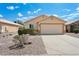 Charming single-story home featuring a two-car garage, desert landscaping, and a well-maintained facade at 1945 W Renaissance Ave, Apache Junction, AZ 85120