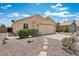 Inviting home exterior with a spacious driveway, low-maintenance landscaping, and a welcoming facade at 1945 W Renaissance Ave, Apache Junction, AZ 85120
