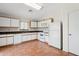 Efficient kitchen with white cabinets, tile flooring, complete appliances, and plenty of counter space at 1945 W Renaissance Ave, Apache Junction, AZ 85120