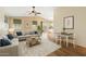 Bright living room featuring modern decor, a ceiling fan, and sliding glass doors to the outdoor space at 1945 W Renaissance Ave, Apache Junction, AZ 85120