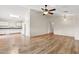 Spacious living room adjacent to kitchen area with contrasting floor finishes, a ceiling fan, and ample lighting at 1945 W Renaissance Ave, Apache Junction, AZ 85120