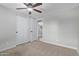 Bedroom featuring plush carpeting, a ceiling fan, and double door closet at 2006 N Arrowhead Dr, Chandler, AZ 85224