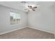Bright bedroom featuring neutral walls, ceiling fan, and a large window with ample natural light at 2006 N Arrowhead Dr, Chandler, AZ 85224
