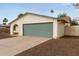 Single-story home with a green garage door, well-maintained landscaping, and an arched entryway at 2006 N Arrowhead Dr, Chandler, AZ 85224